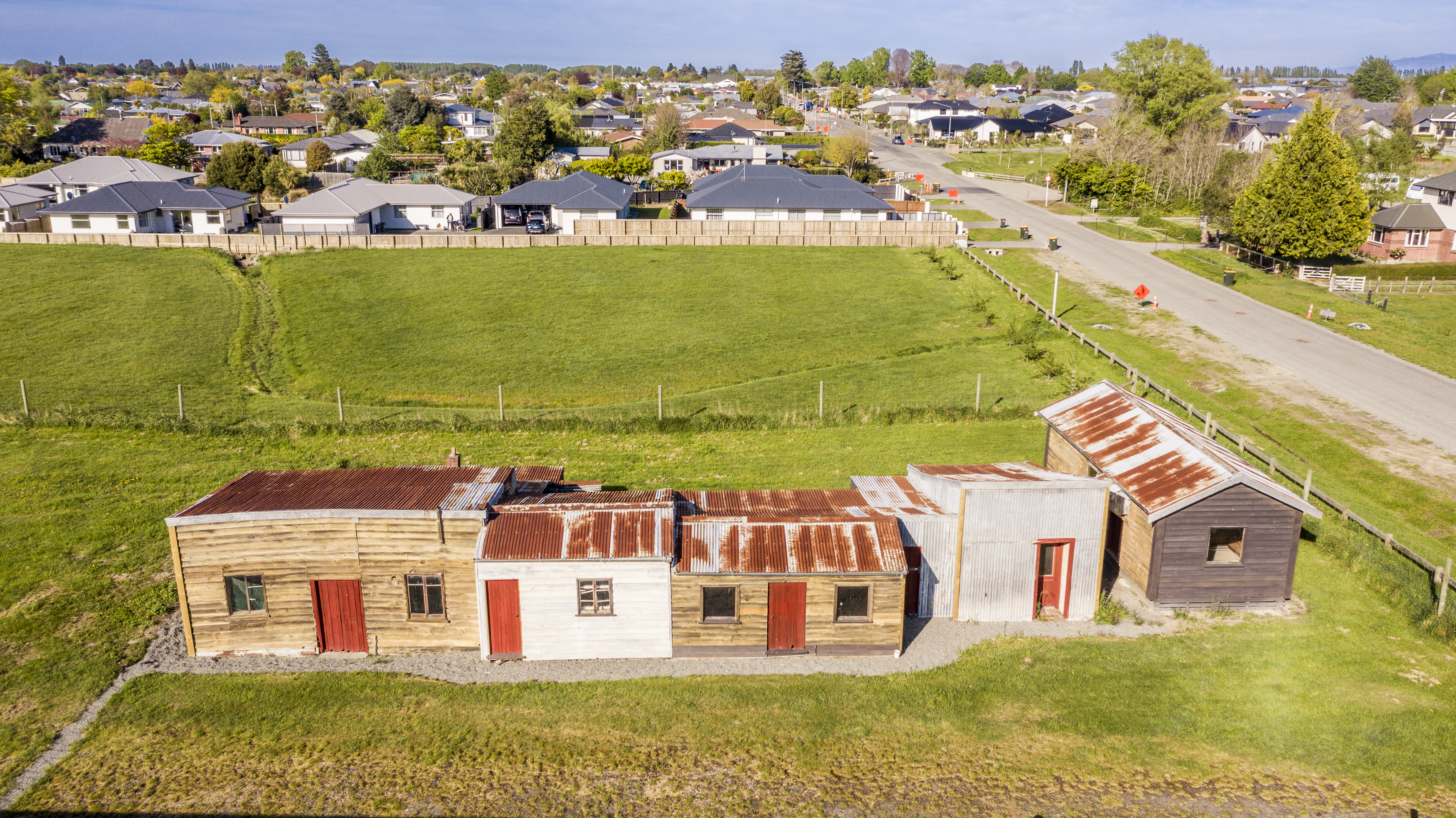 Aerial view of the Ng King Bros. Chinese Market Garden Settlement site showing the former schoolroom, kitchen, living area and sleeping accommodation, October 2023.