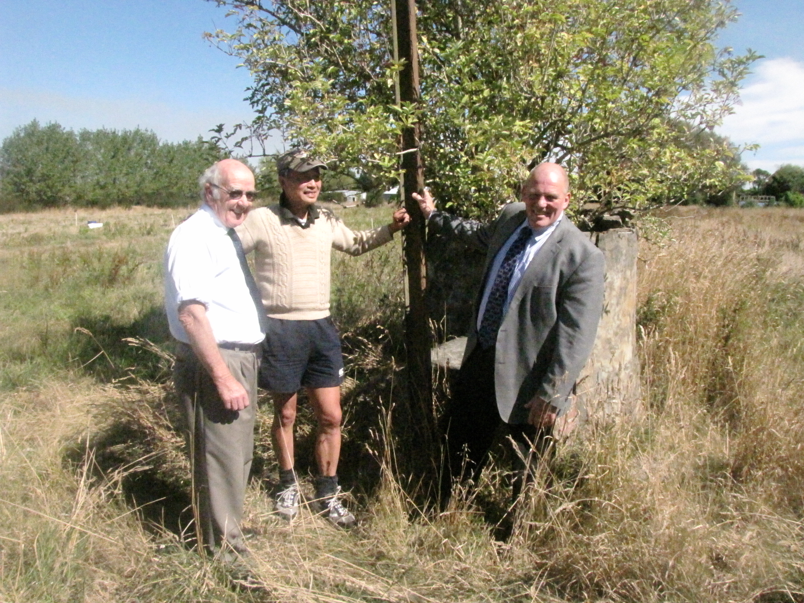 John Rooney, Yep Ng and former Ashburton Mayor Angus McKay standing next to the pig pit oven at the Ng King Bros. Chinese Market Garden Settlement, March 2013.